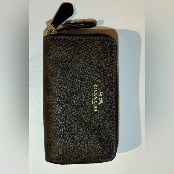 Coach Handbags - A Coach zip around mini sig. canvas wallet.